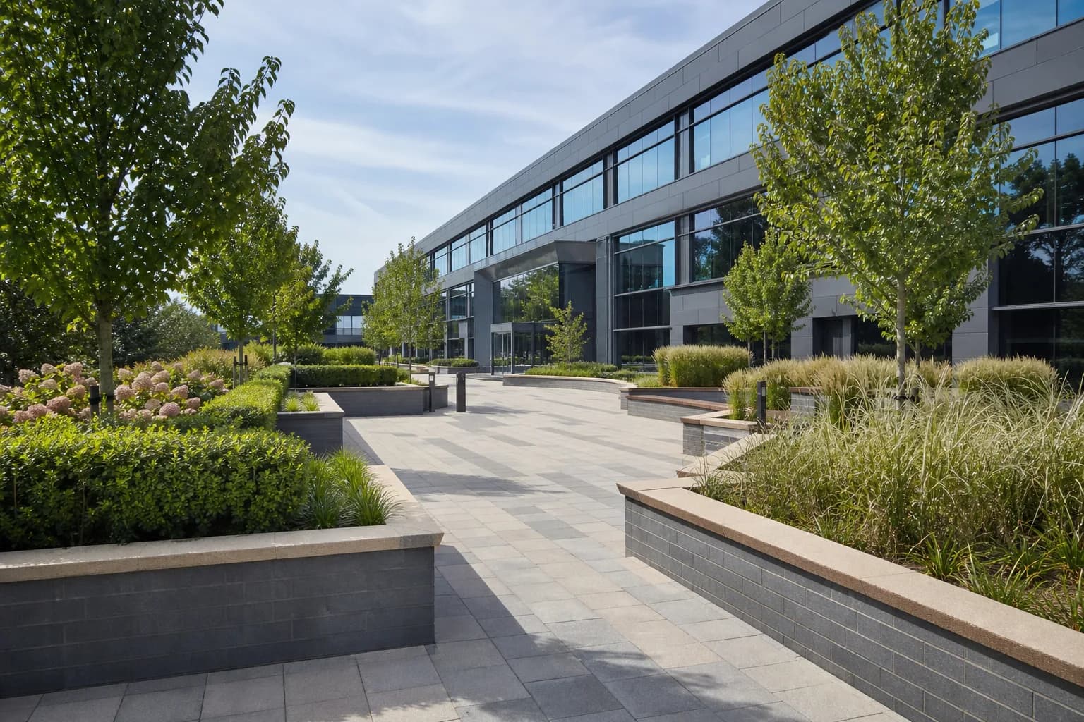 A landscaped commercial courtyard with block paving and planting beds