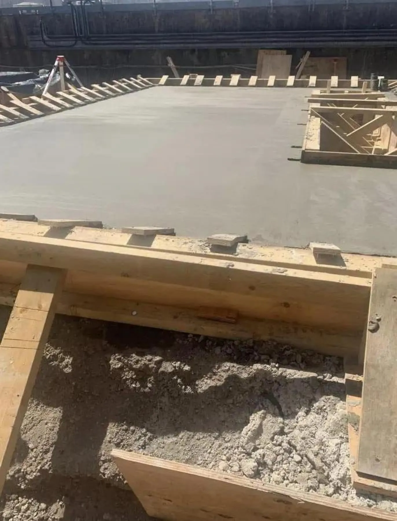 Freshly poured concrete base and groundworks on a garden project